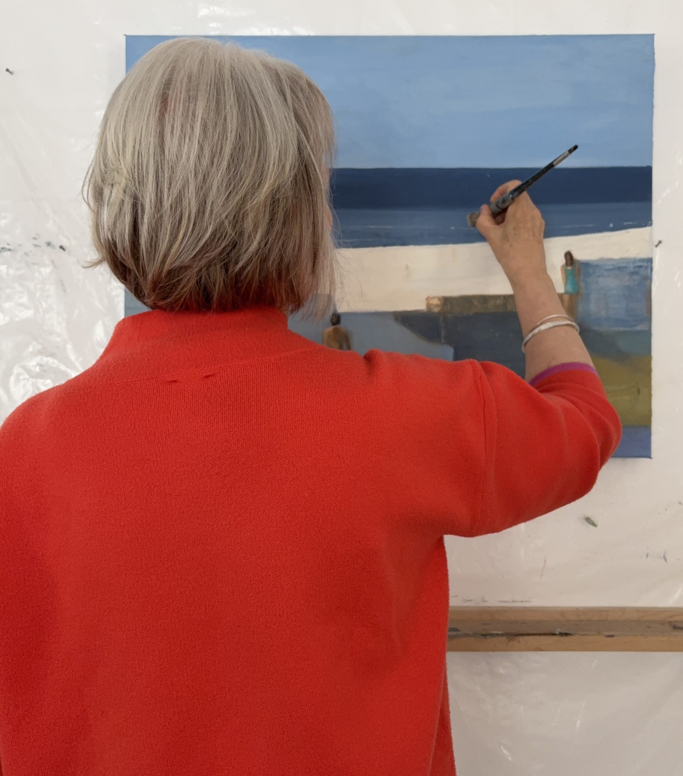 Artist Margaret MacKenzie working on a painting in her studio